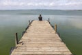 Man On A Dock By The Lake At morning Sky