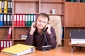 Man with docs in office talking on phone Royalty Free Stock Photo