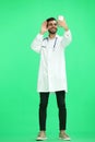 A man doctor conversate with phone on a green background Royalty Free Stock Photo