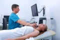 Man doctor diagnostic thyroid gland of ung woman using ultrasound scanner. Royalty Free Stock Photo