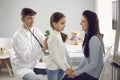 Man doctor pediatrician examining little positive girl patient with stethoscope Royalty Free Stock Photo