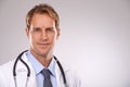 Man, doctor and physician in studio, portrait and medical professional on gray background. Male person, healthcare and
