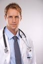 Man, doctor and professional in studio, portrait and medical expert on gray background. Male person, healthcare and