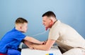 Man doctor sit table medical tools examining little boy patient. Health care. Pediatrician concept. Careful pediatrician Royalty Free Stock Photo