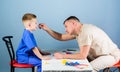 Man doctor sit table medical tools examining little boy patient. Health care. Pediatrician concept. Child care. Careful Royalty Free Stock Photo