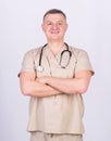 Man doctor with stethoscope physician uniform. Medicine and health care. Professional doctor. Experienced doctor beige