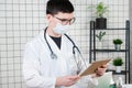 Man doctor surgeon works on a tablet computer in hospital