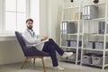 Man doctor therapist looking at camera, listening to patient and making notes in medical clinic Royalty Free Stock Photo