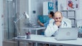 Man doctor typing on laptop in modern office Royalty Free Stock Photo