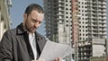 Man with documentation near construction of a new building Royalty Free Stock Photo