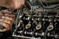 A man does a broach of the head. Makes car repair, engine malfunctioning