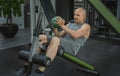 Man does exercises with a ball to pump the muscles of the press on a sports bench Royalty Free Stock Photo