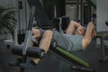 Man does exercises with a ball to pump the muscles of the press on a sports bench Royalty Free Stock Photo