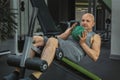 Man does exercises with a ball to pump the muscles of the press on a sports bench Royalty Free Stock Photo