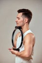 A man does exercises for the neck on reformers during Pilates, a young man shows exercises for the cervical spine during