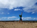 Man does Handstand on beach with clouds in the sky Royalty Free Stock Photo