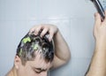 Man does head scrub. Dark-haired young man applies a scalp scrub to combat dandruff, oily scalp, alopecia. Problem skin causing