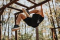 A man does pull ups outdoors in a forest. He enjoys a sunny day hiking, surrounded by trees. Royalty Free Stock Photo