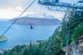 The man does solo bungee jumping from a platform at the top of the Gondola in Queenstown provided by The Ledge Swing. Royalty Free Stock Photo