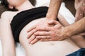 A man does a woman a massage of the abdomen, osteopathy 3 Royalty Free Stock Photo