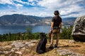 Man and dog admiring the lake view. Royalty Free Stock Photo