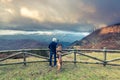 Man and dog admiring view in mountains Royalty Free Stock Photo