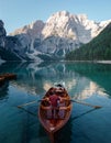 Man and dog in a boat on a mountain lake. Trip with a pet to Italy. Australian Shepherd Dog and its owner Royalty Free Stock Photo