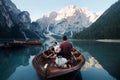 Man and dog in a boat on a mountain lake. Trip with a pet to Italy. Australian Shepherd Dog and its owner Royalty Free Stock Photo