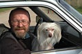 Man with dog in car