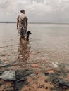 Man & Dog in Clear Shallow Water at Chequamegon Bay in Wisconsin