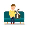 Man with dog. Friends together. Young businessman sitting on couch. Beside him puppy. Concept of human and animal friendly. Royalty Free Stock Photo