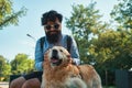 Man and dog having fun, playing, making funny faces while restin Royalty Free Stock Photo