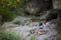 Man and dog. Miniature Schnauzer near canyon. Enjoing the time outside. Green trees and mountains on the background. Royalty Free Stock Photo