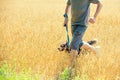 A man with a dog runs through the oat field Royalty Free Stock Photo