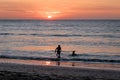 Man and dog silhouette at Beautiful sunset in Mancora Beach - Mancora, Peru Royalty Free Stock Photo