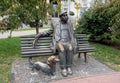 Man with a dog sitting on a bench