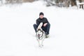 Man in dog sledding travel across snow field Royalty Free Stock Photo