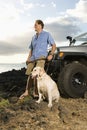 Man and Dog by SUV at the Beach Royalty Free Stock Photo