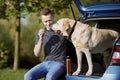 Man with dog traveling by car Royalty Free Stock Photo