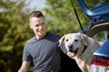 Man with dog traveling by car Royalty Free Stock Photo