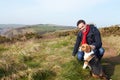 Man With Dog Walking Along Coastal Path Royalty Free Stock Photo