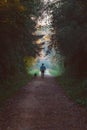 Man and dog walking in a natural tunnel