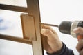 Man doing aluminum frame with glasses and wire screen door and window