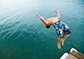 Man doing back-flip into lake