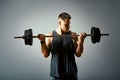 Man doing back workout, barbell row in studio over gray background Royalty Free Stock Photo