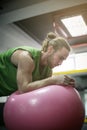 Man doing balance exercises with fit ball. Royalty Free Stock Photo