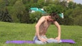 Man doing belly motion Nauli Kriya Yoga technique on the grass in India