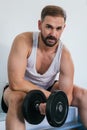 Man doing biceps exercises with dumbbells at the gym. sitting on a bench. health and wellness concept Royalty Free Stock Photo