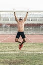 Man Doing Chin-ups outdoor.