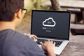 Man doing cloud uploading on laptop / computer